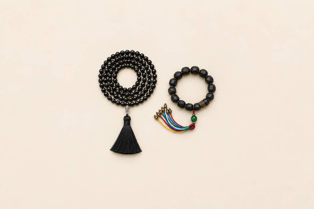 A larger coiled strand-like form with a black tassel beside a smaller circular form with colored cord ends