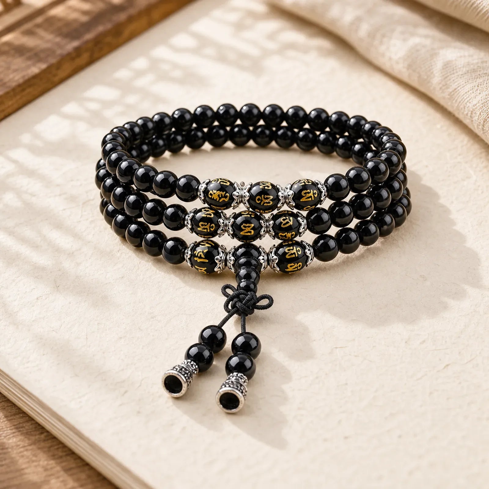 Black Obsidian Six True Words Protection Mala Bracelet featuring Black Obsidian, Om, Six True Words (Om Mani Padme Hum)