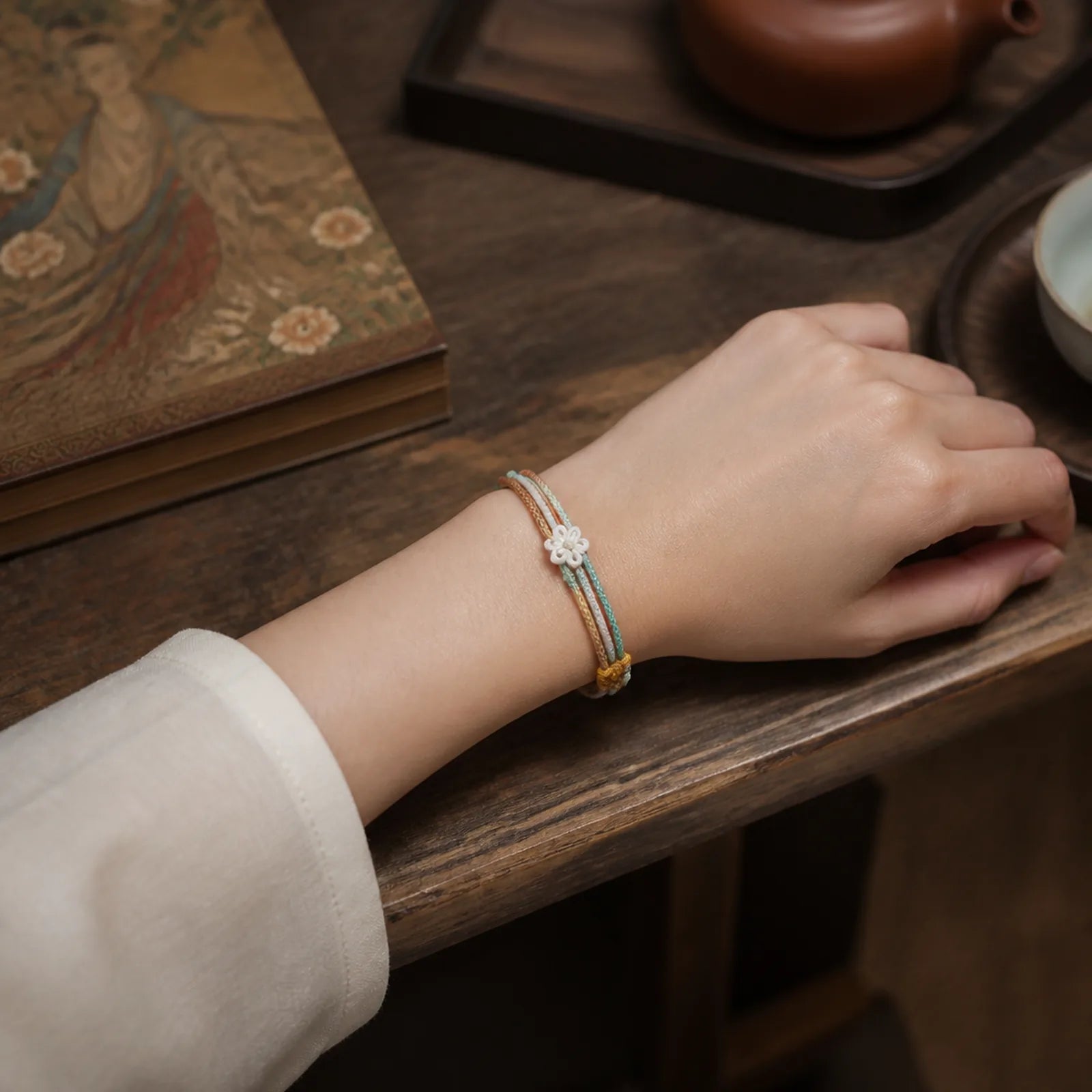 Handmade Dunhuang Color Peach Blossom Pattern Braid String Bracelet featuring Red String