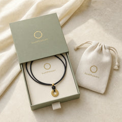 "Wishing You Good Fortune" 24k Gold Plated Brass Peace Buckle Black Rope Necklace Includes Gift Message Card featuring Peace Buckle, Copper