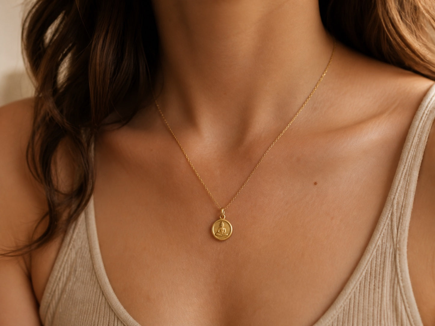 Customer wearing a gold Buddha necklace